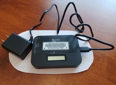 Betsie Valley District Library Hotspot with a charging cord.